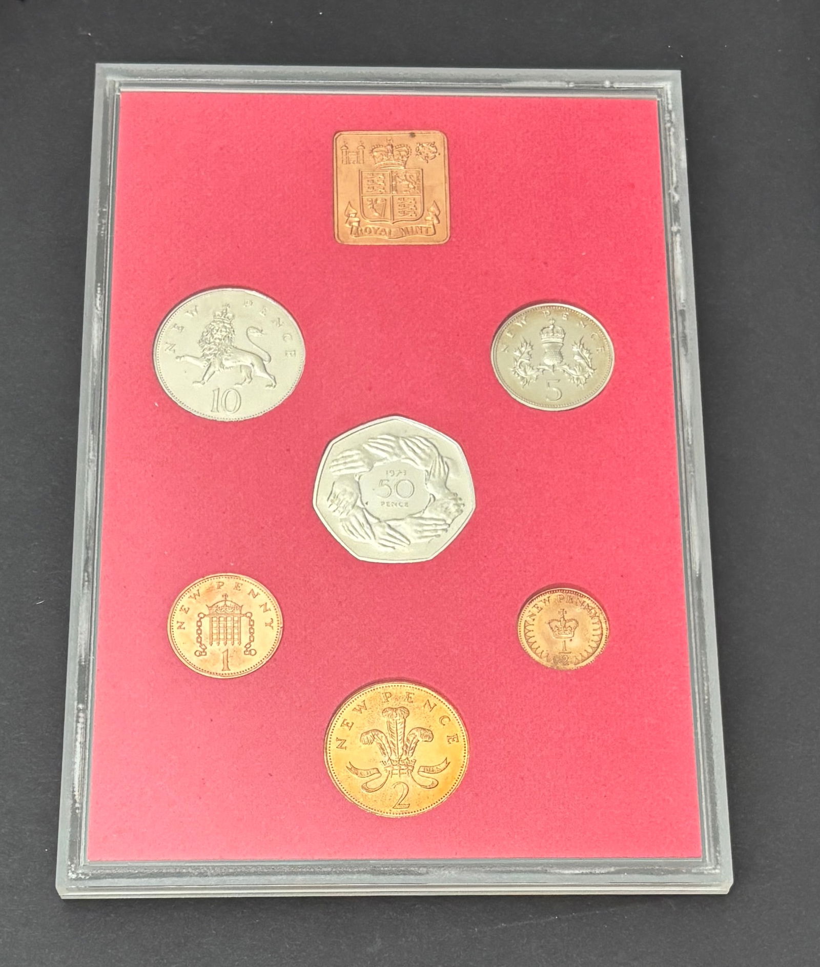1973 Great Britain Royal Mint Proof Coin Set in Original Case: Complete 1973 United Kingdom Royal Mint proof set housed in the original fitted display case and holder. The set includes seven coins: ½ Penny, 1 Penny, 2 Pence, 5 Pence, 10 Pence, and 50 Pence