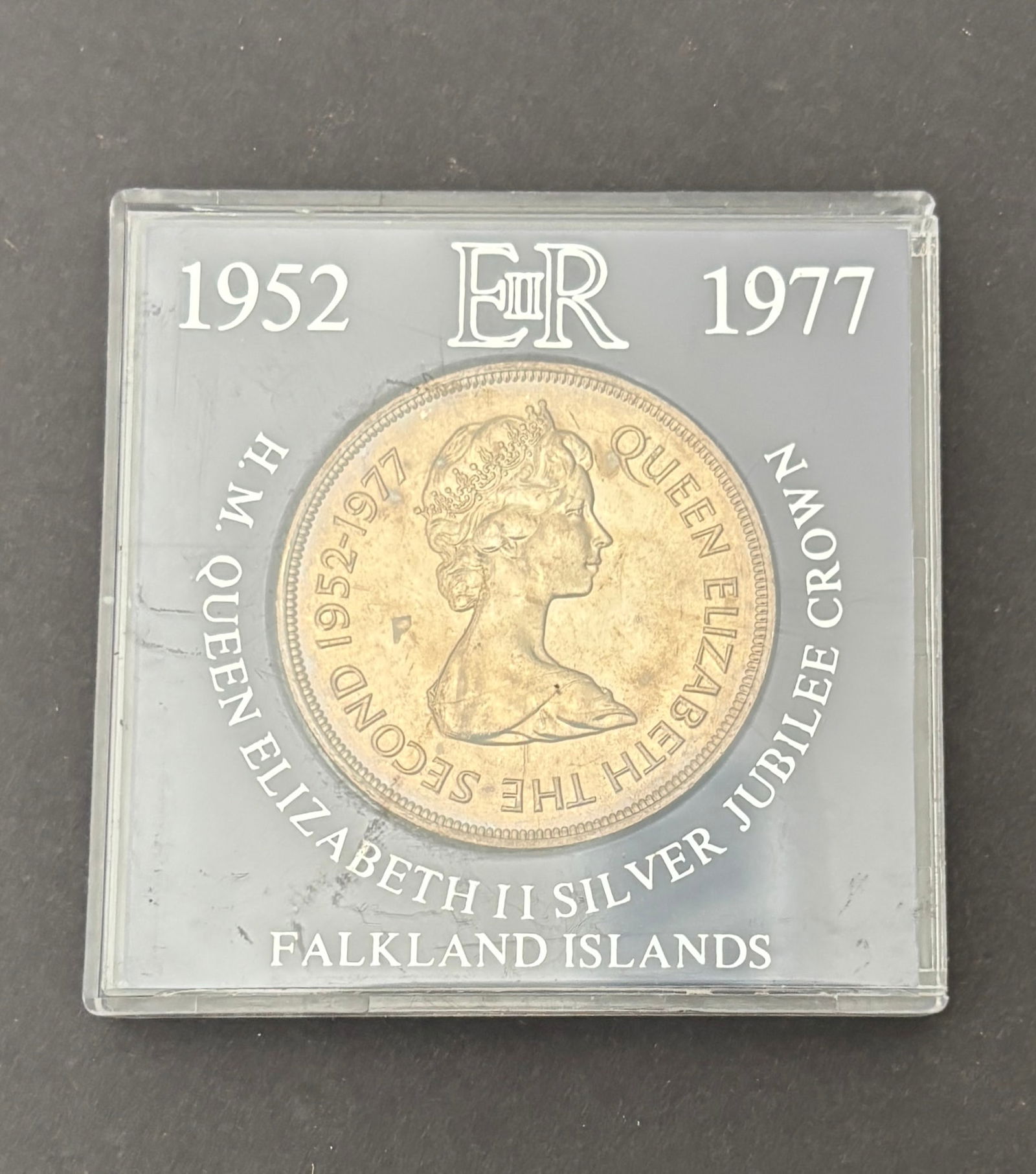 1977 Falkland Islands Silver Jubilee Fifty Pence Coin: 1977 Falkland Islands Fifty Pence commemorating the Silver Jubilee of Queen Elizabeth II (1952–1977), featuring the crowned portrait of Queen Elizabeth II on the obverse and the Falkland Islands coa