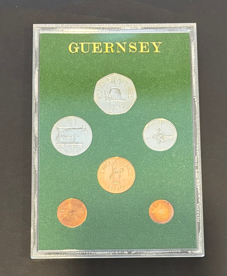 1970 Guernsey Proof Coin Set In Presentation Case: 1970 Guernsey proof coin set featuring six denominations including 50 new pence, 10 pence, 5 pence, 2 pence, 1 penny, and half penny, displaying traditional Guernsey designs such as the cow and island