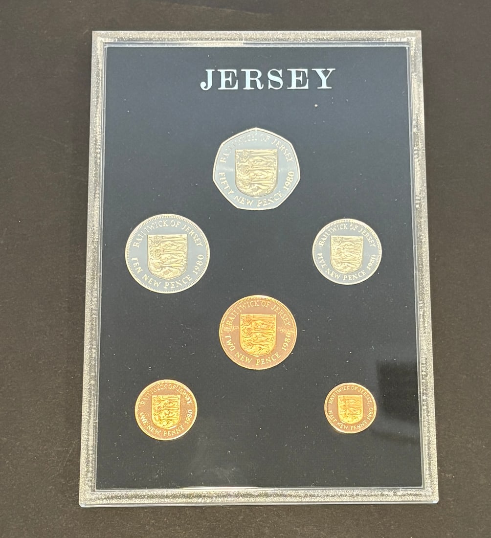 1980 Jersey Proof Coin Set In Presentation Case: 1980 Bailiwick of Jersey proof coin set featuring six denominations including 50 new pence, 10 new pence, 5 new pence, 2 new pence, 1 new penny, and half new penny, each displaying the Jersey shield a