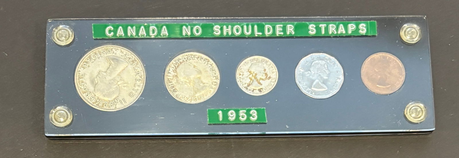 1953 Canada No Shoulder Strap Proof like Coin Set In Display Holder: 1953 Canada “No Shoulder Strap” five-coin prooflike year set mounted in custom acrylic display holder. Set includes silver dollar, 50 cents, 25 cents, 10 cents, 5 cents, and bronze 1 cent, all