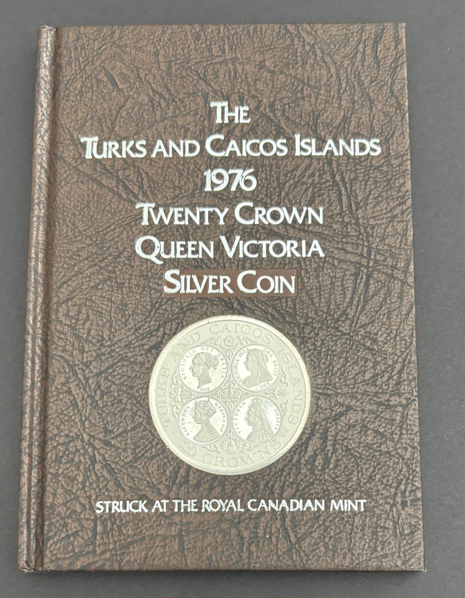 1976 Turks and Caicos Islands Twenty Crown Queen Victoria Silver Proof Coin: 1976 Turks and Caicos Islands Twenty Crown Queen Victoria commemorative proof coin struck at the Royal Canadian Mint and housed in the original book-style presentation case with certificate of authent