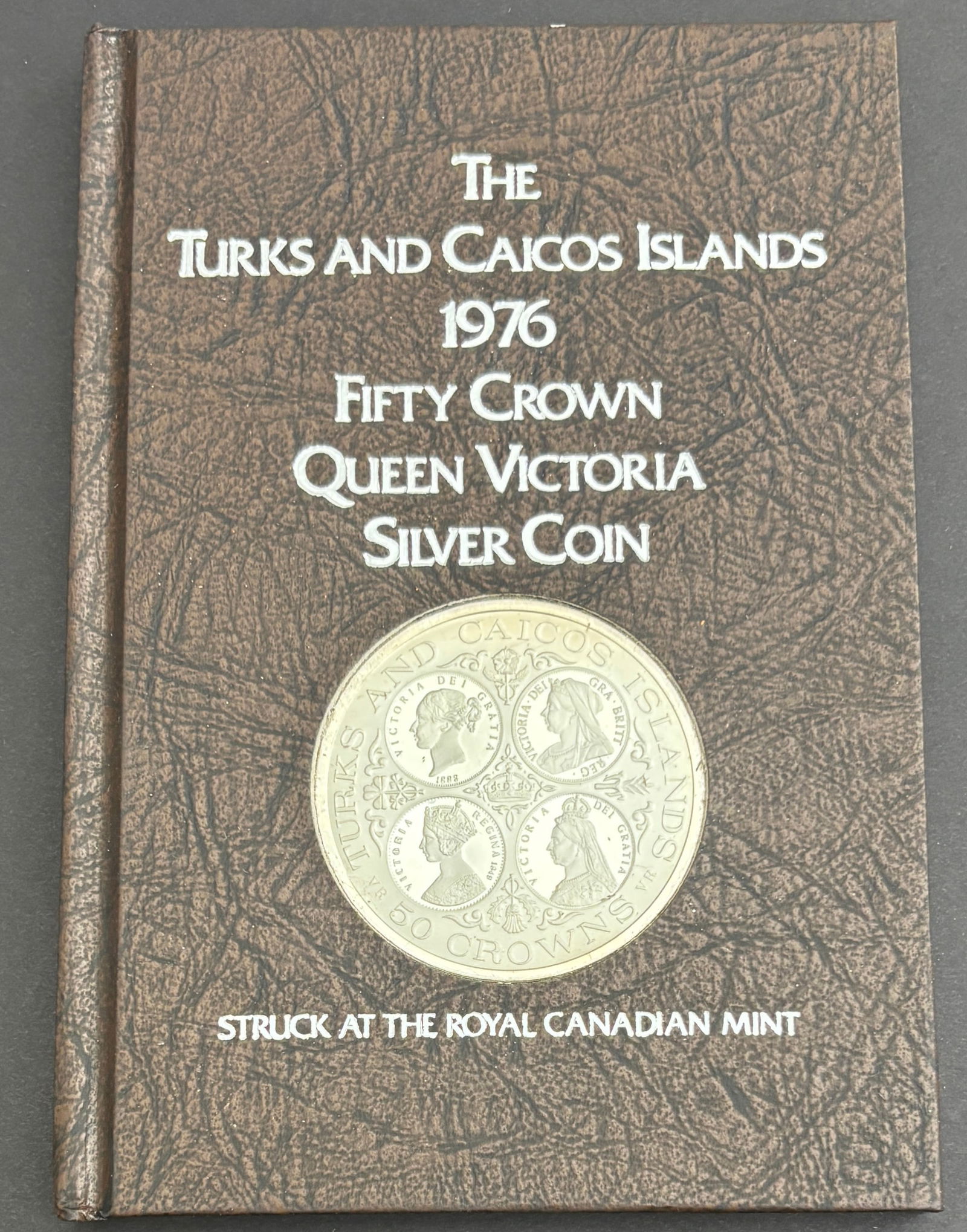 1976 Turks and Caicos Islands Fifty Crown Queen Victoria Silver Proof Coin: 1976 Turks and Caicos Islands Fifty Crown Queen Victoria commemorative proof coin struck at the Royal Canadian Mint and presented in the original book-style presentation case with certificate of authe