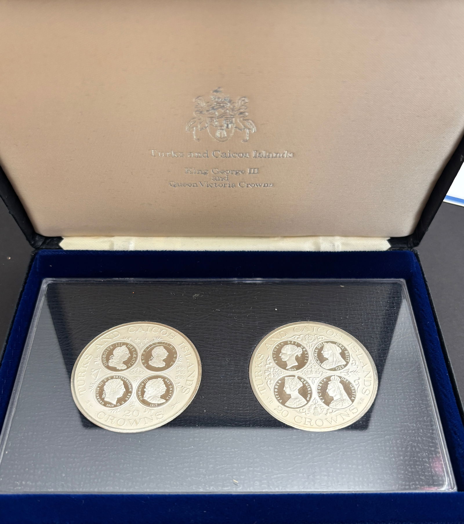 1977 Turks and Caicos Islands King George III & Queen Victoria Two 20 Crowns Silver Proof Set: 1977 Turks and Caicos Islands two-coin 20 Crowns commemorative proof set struck at the Royal Canadian Mint and presented in the original fitted case with certificate of authenticity. Both large format