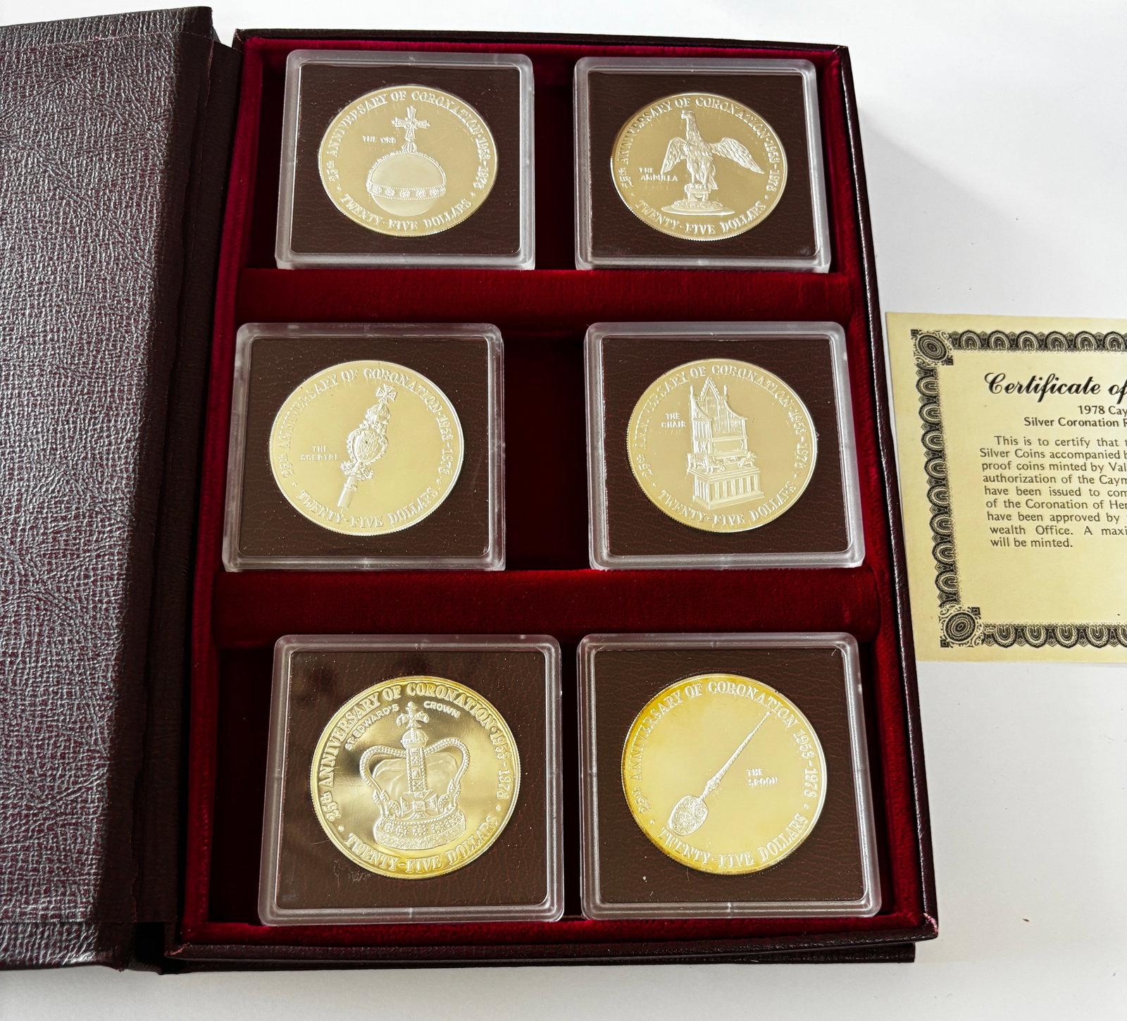 1978 Cayman Islands Silver Coin Set: 1978 Cayman Islands Coronation Regalia silver coin collection issued for the 25th anniversary of the coronation of Queen Elizabeth II (1953–1978), comprising six $25 proof coins depicting royal rega