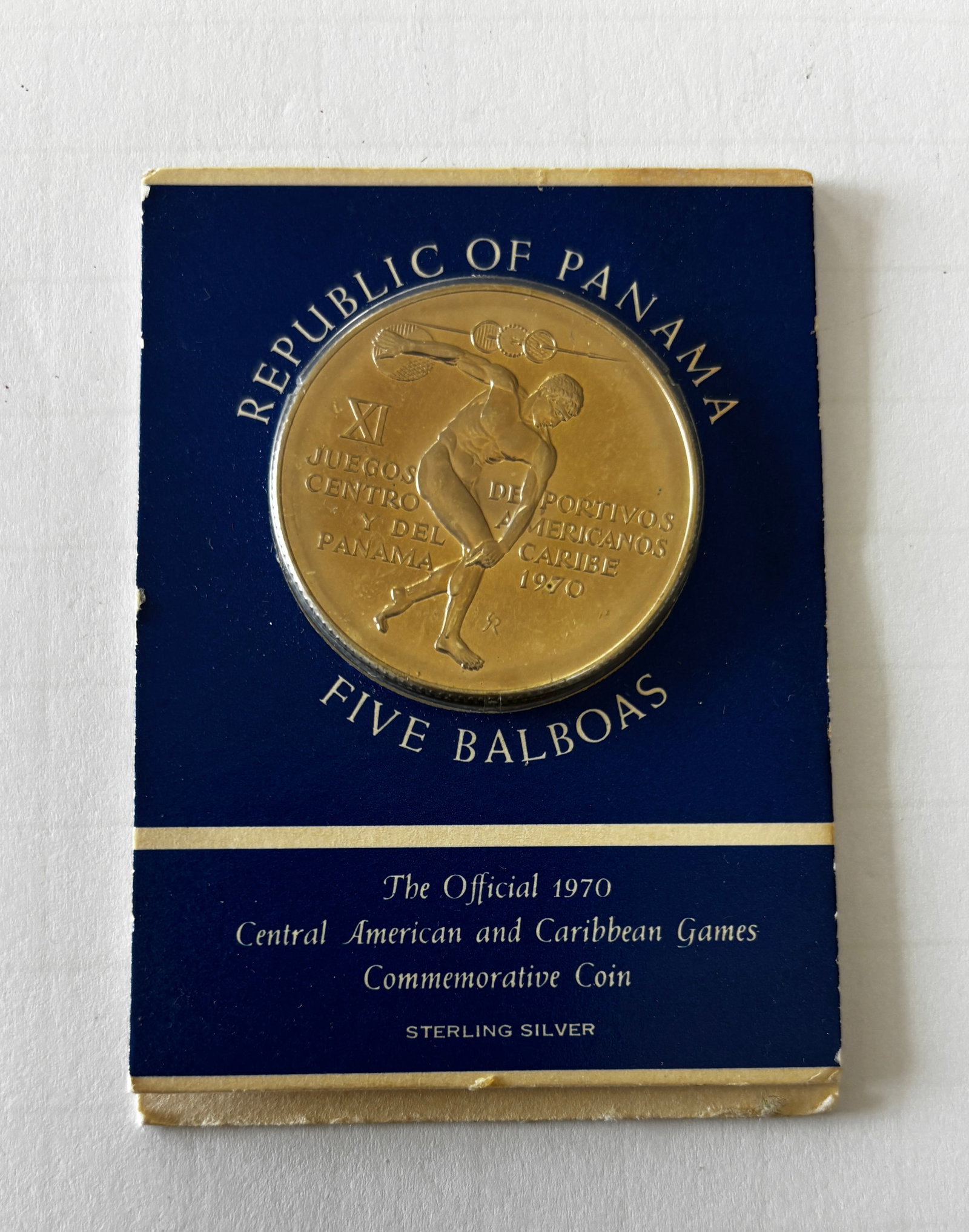 1970 Panama 5 Balboas Sterling Silver Coin: Republic of Panama 1970 Five Balboas commemorative coin issued for the XI Central American and Caribbean Games, housed in original presentation holder. Sterling silver composition with athletic discus