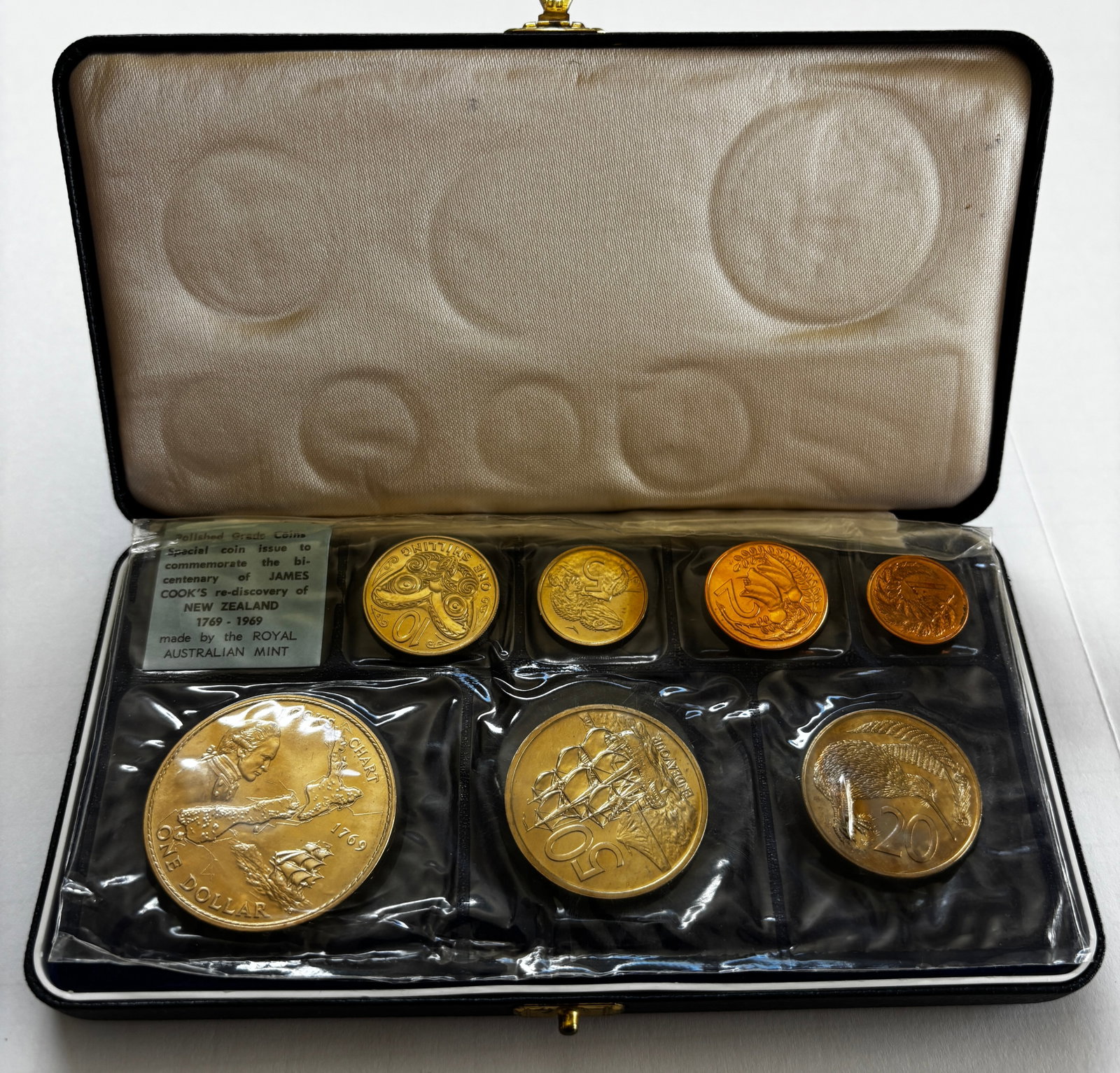 1969 New Zealand Proof Coin Set: 1969 New Zealand polished grade proof coin set issued to commemorate the bicentenary of James Cook’s rediscovery of New Zealand, housed in original fitted presentation case. Includes seven coins fro