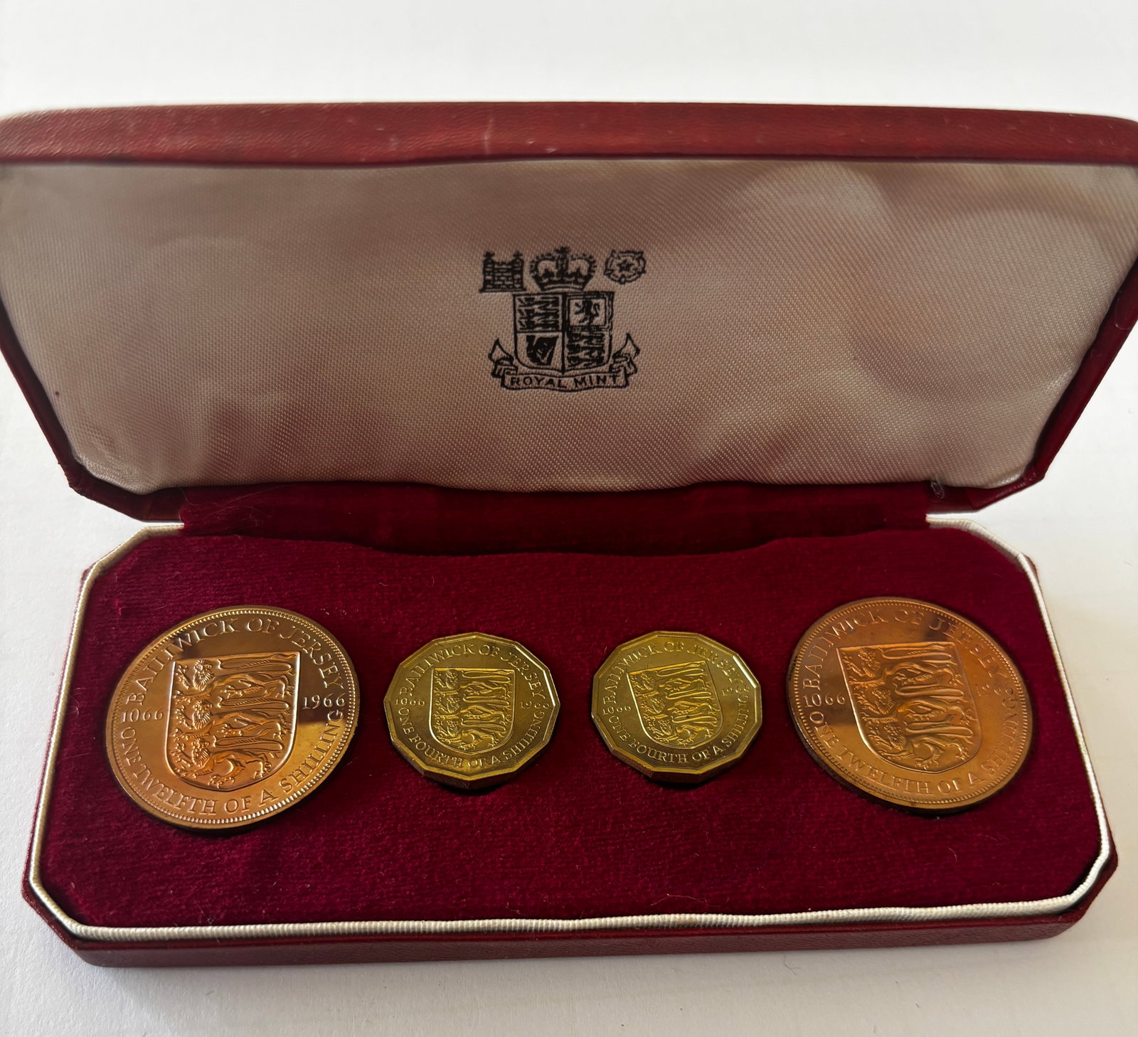 1966 Bailiwick of Jersey Coin Set: 1966 Bailiwick of Jersey commemorative coin set comprising multiple denominations including one-twelfth of a shilling, one-quarter of a shilling, and larger format pieces, struck in bronze and brass c