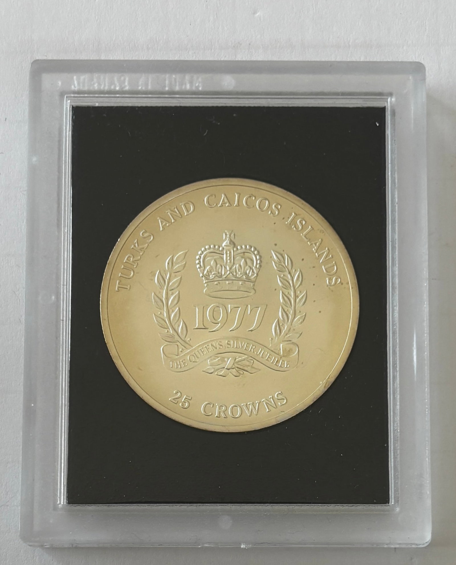 1977 Turks & Caicos 25 Crowns Jubilee Coin: 1977 Turks and Caicos Islands 25 Crowns commemorative coin issued for the Silver Jubilee of Queen Elizabeth II (1952–1977), struck at the Royal Canadian Mint in cupro-nickel with uncirculated/specim