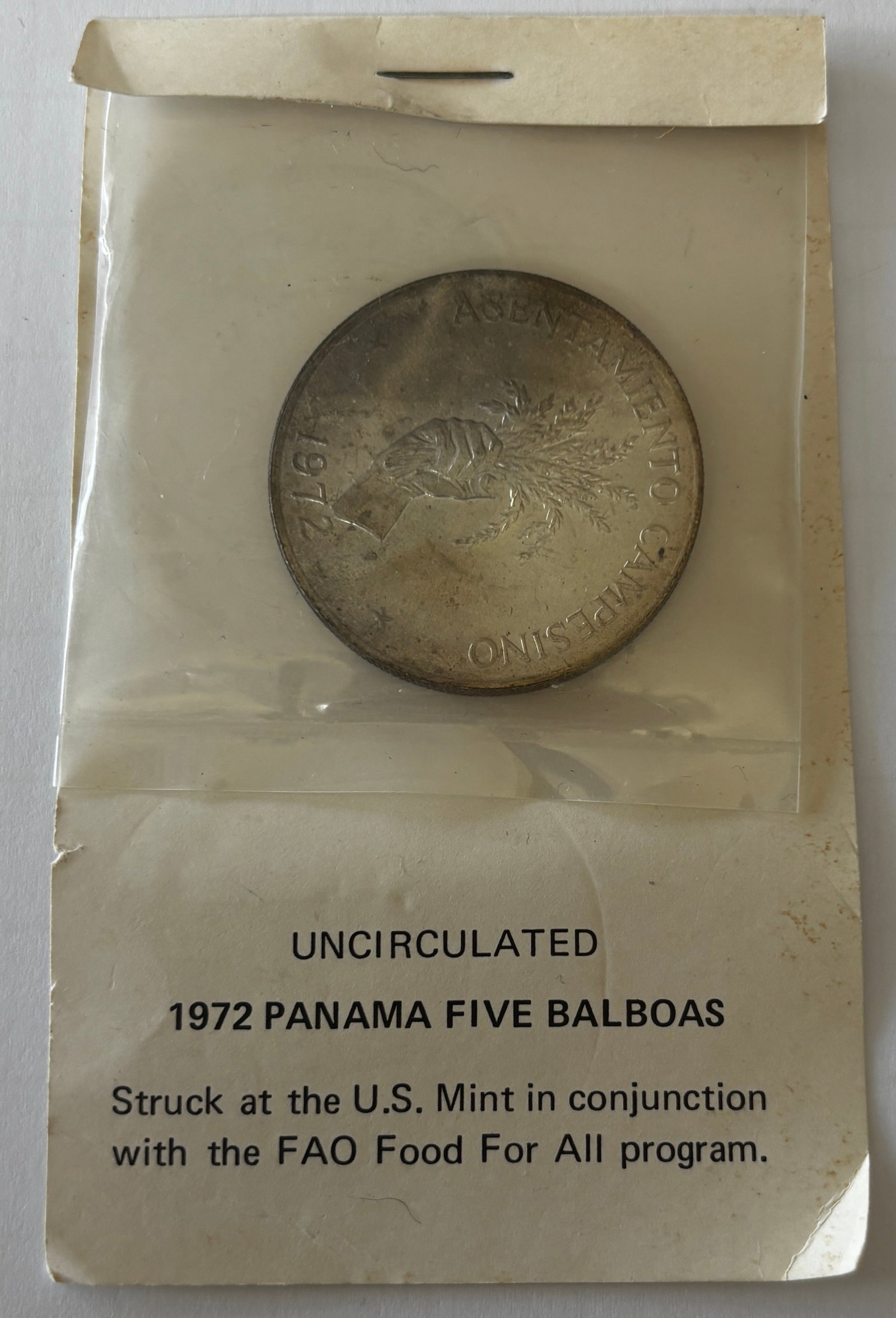1972 Panama 5 Balboas FAO Coin: 1972 Panama Five Balboas coin issued for the FAO Food for All program, struck at the U.S. Mint, featuring a hand grasping wheat on obverse and Panamanian coat of arms on reverse, large format crown-si