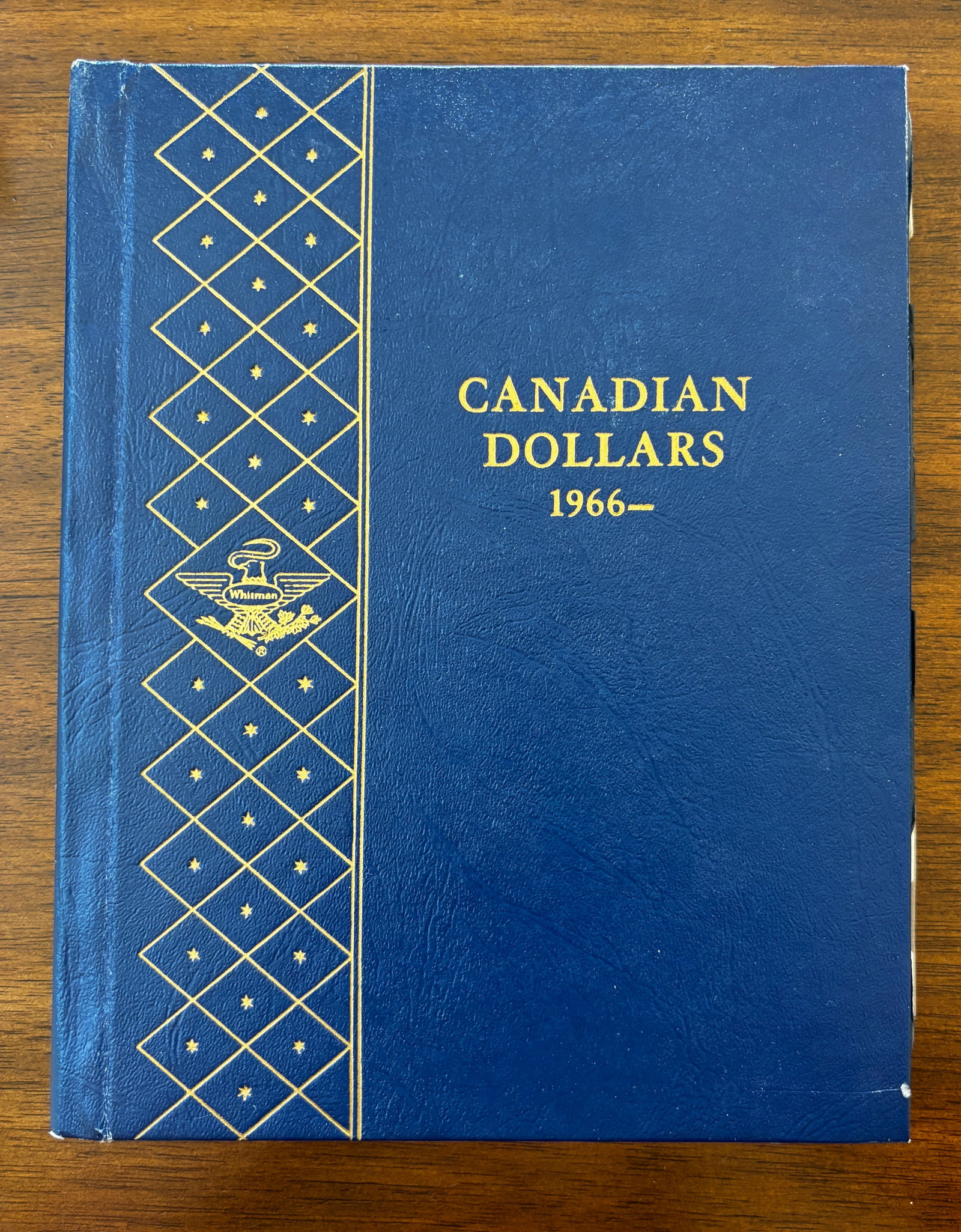 Whitman Canadian Dollars Album 1966–Date with Commemorative & Silver Issues: Whitman Canadian Dollars album containing a collection of Canadian dollar coins from 1966 through the early 1980s with additional modern commemorative and silver issues. The album includes numerous re