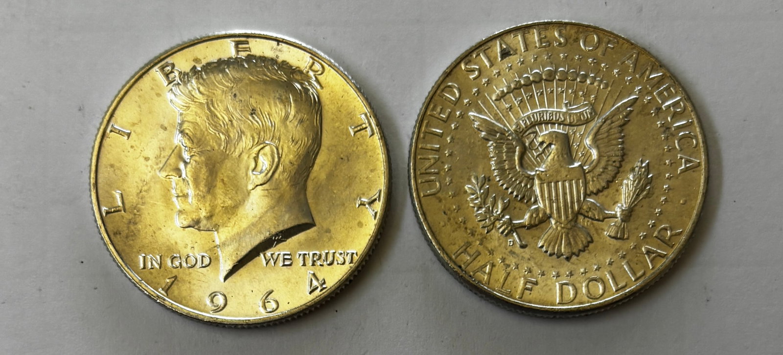 Lot of 20 Kennedy Half Dollars (1964): Collection of twenty (20) United States 1964 Kennedy Half Dollars. These first-year Kennedy half dollars feature the portrait of President John F. Kennedy on the obverse and the Presidential Seal reve
