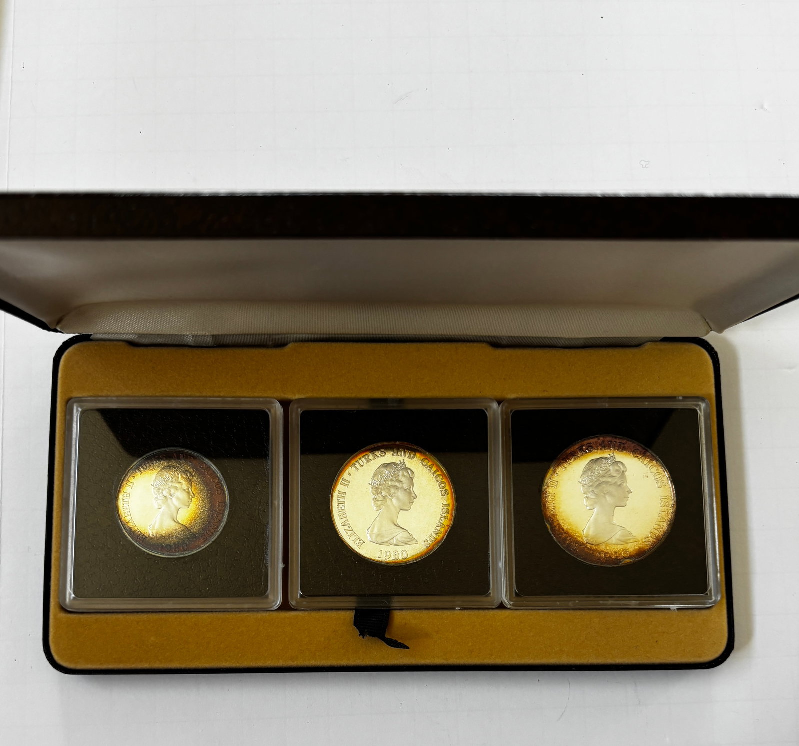 Turks & Caicos Islands 1980 Silver Proof Crown Set: Three-piece silver proof crown set issued by the Turks & Caicos Islands in 1980 honoring Louis Mountbatten. Includes 5 Crown, 10 Crown, and 20 Crown proof silver coins housed in the original presentat