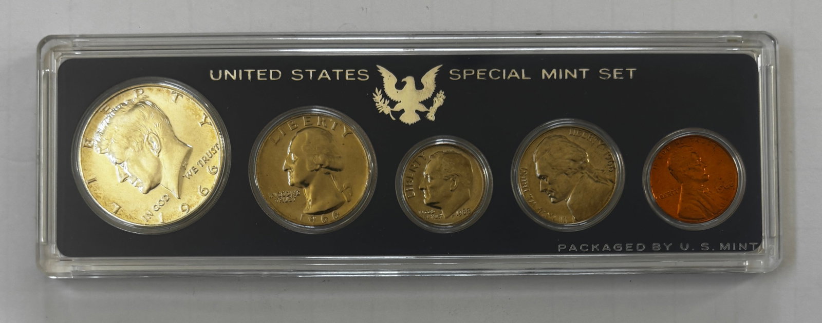 1966 United States Special Mint Set (SMS), Complete Five-Coin Set: Official 1966 United States Special Mint Set (SMS) containing five coins housed in the original hard plastic Mint holder. The set includes the 1966 Kennedy half dollar, Washington quarter, Roosevelt d