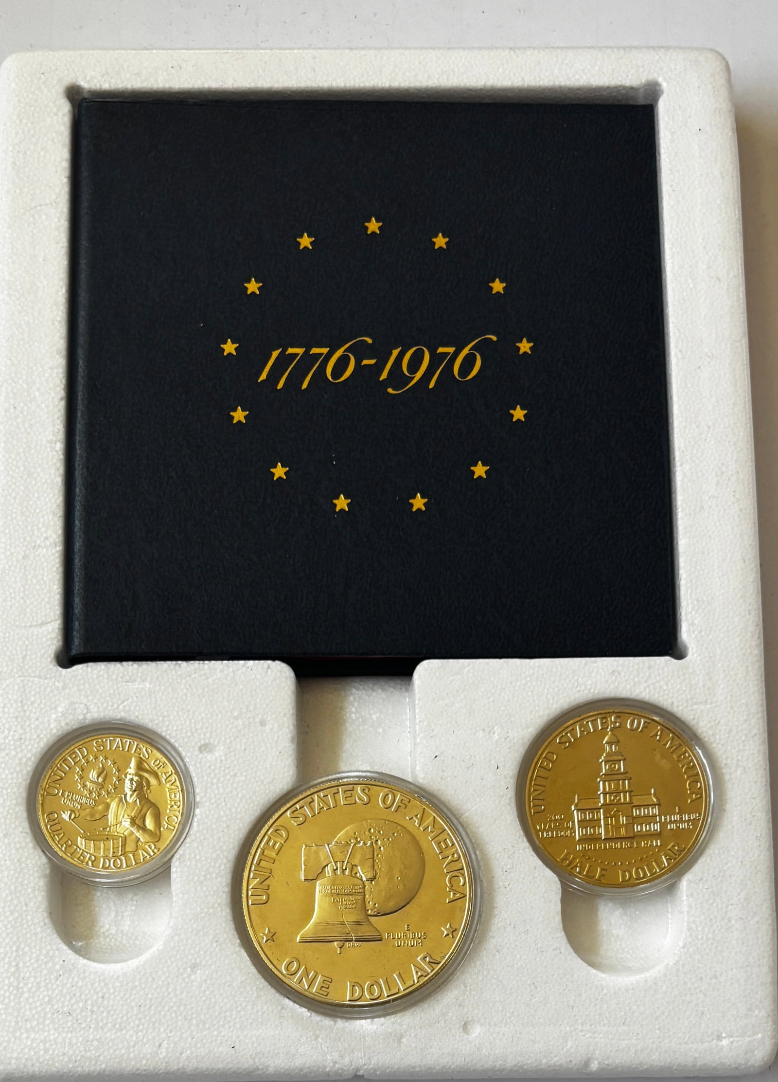 1976 Bicentennial Proof Three-Coin Set in Original Presentation Folder: Official 1976 United States Bicentennial Proof Set featuring the three special dual-dated 1776–1976 proof coins issued to commemorate America’s Bicentennial. The set includes the Washington Quarte