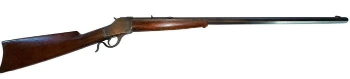 Winchester Model 1885 Single Shot Rifle .45-60 WCF: Winchester Model 1885 single shot rifle chambered in .45-60 WCF, featuring an octagonal barrel, walnut stock, and blued steel components with classic falling block action; barrel marked “45-60 W.C.F