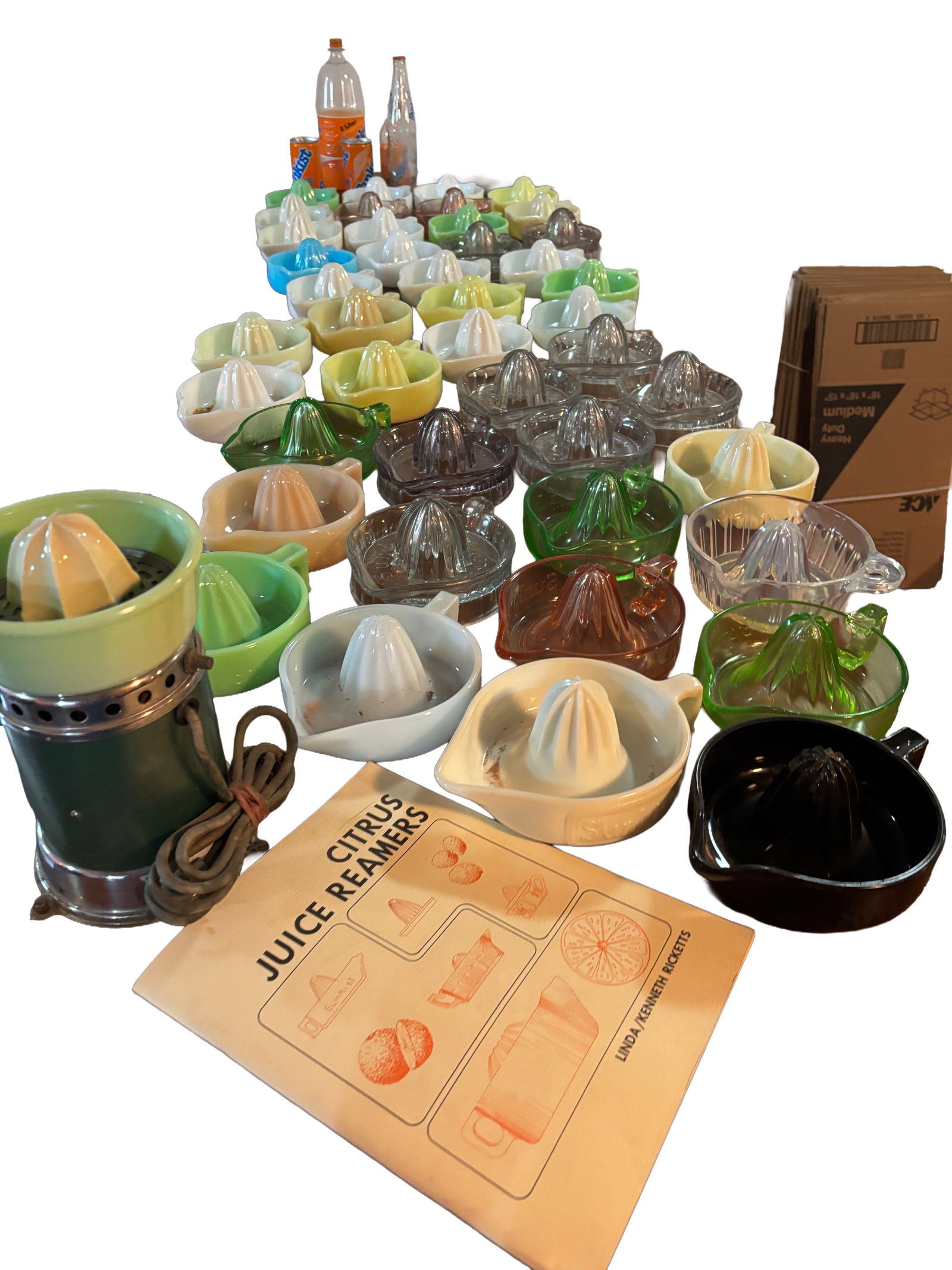 Large Collection of Vintage Glass & Ceramic Citrus Juice Reamers with Sunkist Juicit: Extensive collection of vintage citrus juice reamers and juicers in assorted glass and ceramic examples, including clear, green, pink, blue, yellow, white, and jadeite-style colors. Various forms incl