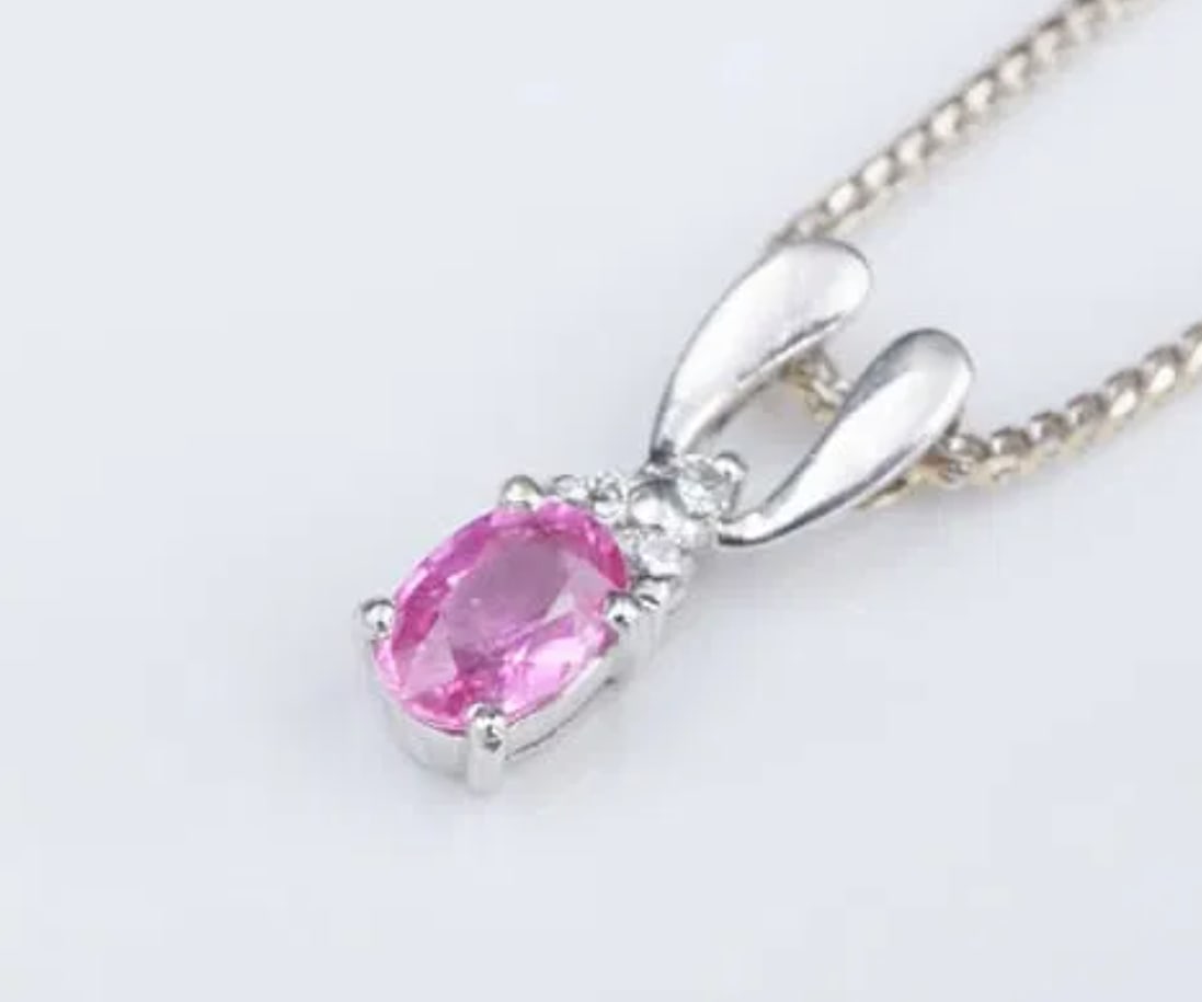 14k White Gold 2/3cttw Diamond Pink Sapphire Drop Pendant Necklace 18" NG1249: This lovely necklace features a vivid pink sapphire accented with a trio of sparkling diamonds. All crafted in solid 14k white gold. The pendant slides smoothly on a supple Chopin chain with a lobster