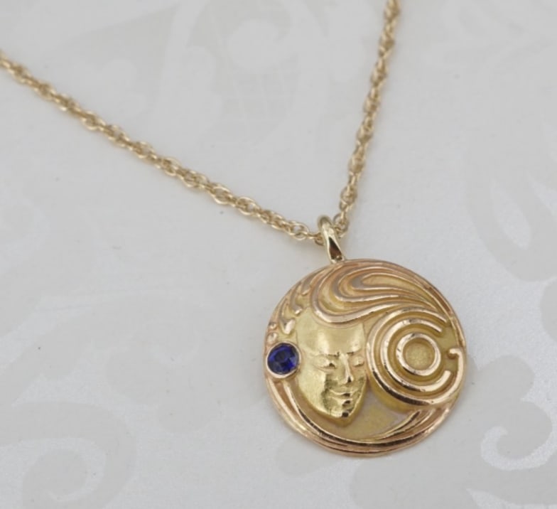 Dieges & Clust 14k Yellow Gold Sapphire Face Charm Pendant Necklace 18" NG1815: This beautiful vintage necklace centers on a medallion charm featuring a face with flowing hair accented with a deep blue sapphire. Crafted in 14k yellow gold, and suspended elegantly from a supple ro