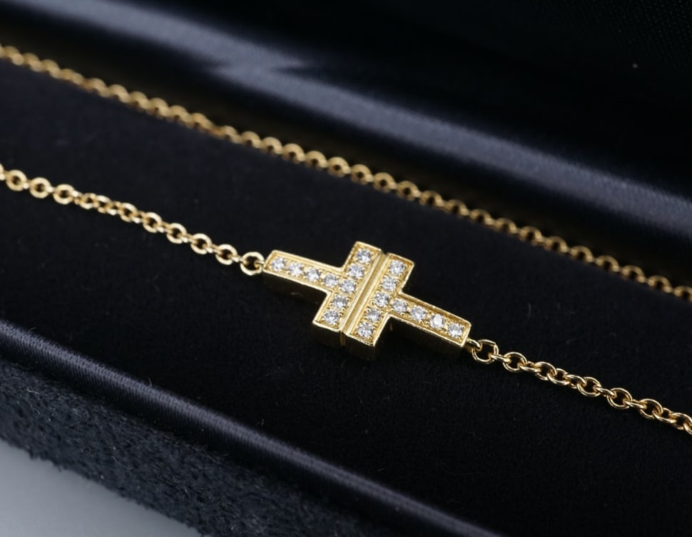 Tiffany & Co. Double T Diamond Wrap Bracelet 18k Yellow Gold 12" w/ Box BG1095: This adorable Tiffany & Co. bracelet centers on the classic Tiffany double-T set with diamonds, with sturdy cable chain extending from each side. All crafted of solid 18k yellow gold, this piece is am