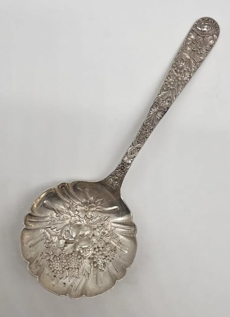 S. Kirk and Son Repousse Sterling Silver Berry Spoon: This lovely S. Kirk and Son spoon features a delicate Repousse pattern, including summer flowers, leaves and fruits all throughout the handle and bowl. The spoon is marked sterling and signed on verso