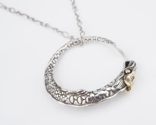 John Hardy Naga Legends Dragon Pendant Necklace Sterling Silver 18k Gold NS2304: This gorgeous necklace from John Hardy features a circular pendant embellished with an ornate dragon motif with 18k yellow gold eyes. Suspended from an alternating link chain crafted in solid sterling