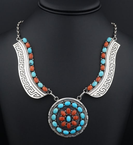 E. Etsitty Navajo Sterling Silver Coral Turquoise Wing Bib Necklace 21" NS2062: This beautiful necklace is a bright and bold splash of color! Featuring a combination of turquoise and coral cabochons arranged in a circular naja pendant and lining the sterling silver "wings" of the
