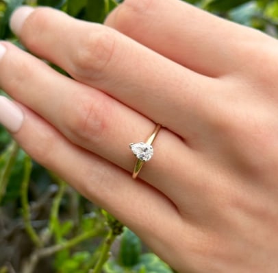 14k Pear Diamond Engagement Ring Yellow Gold Natural Size 5.25 Solitaire RG4530: This classic ring centers on a natural pear cut white diamond prong set atop a slim 14k yellow gold band. The lively center stone flashes with every move, high set for maximum light play. This ring wo