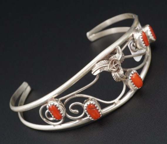 Navajo Sterling Silver Coral Cuff Bracelet Open Swirl Carolyn Nez 6.75" BS2806: This lovely cuff bracelet features an opal swirl design with a flower and coral accents. The split shoulders provides an added visual touch. A simple statement piece and a great addition for any colle