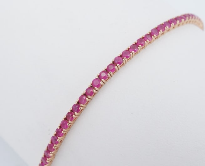 14k Rose Gold Natural Ruby Tennis Bracelet 7" 3ct BG1112: This colorful statement bracelet is crafted of solid rose gold, set with natural rubies. The bracelet fastens with a secure insert clasp and safety catch for added security. An eye-catching look that