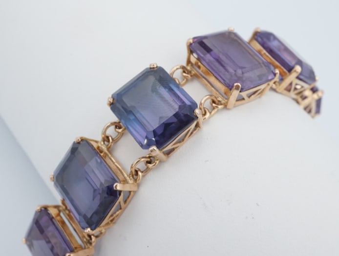Mid-Century Egyptian 18K Gold Color-Change Sapphire Statement Bracelet BG1123: This captivating bracelet is a true treasure for lovers of vintage jewelry and unique gemstones. Crafted from luxurious yellow gold, it features a captivating line of chunky lab color-change sapphires