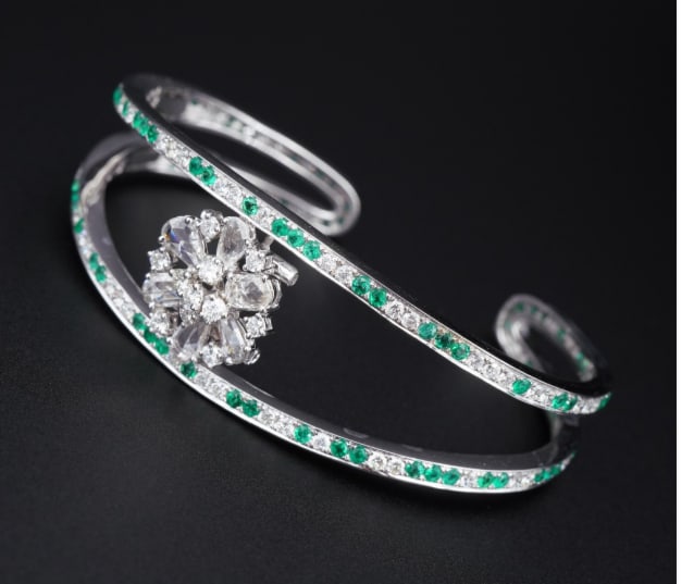 18k White Gold 4.5 carat Diamond Emerald Kick Cuff Bracelet 6.25" BG729: This luxe bracelet features two beautiful lines of alternating emeralds and diamonds, all set in solid 18k white gold, with a gorgeous diamond cluster at center. One arm has a kick-out hinge to make f