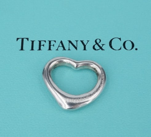 Tiffany & Co Open Heart Pendant Elsa Peretti Sterling Silver 21mm PS2153: This classic Tiffany & Co. pendant by designer Elsa Peretti features a classic open heart design crafted of solid sterling silver. Described by Tiffany as "The simple, evocative shape of Elsa Peretti