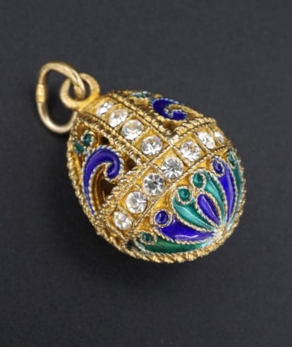 Russian Sterling Vermeil Enamel Crystal Imperial Style Egg Pendant 1.2" PS2030: Inspired by the beautiful eggs of Faberge, this egg pendant is crafted of sterling silver with gold vermeil and features blue and green enamel with sparkling crystal accents. Swirl cutouts and milgrai