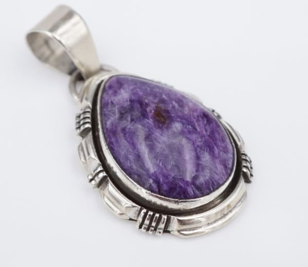 Navajo L Yazzie Sterling Silver Purple Sugilite Pendant Cabochon 1.8" PS2097: This Navajo pendant, from the illustrious Yazzie family, features a beautiful teardrop purple sugilite cabochon set in a scalloped frame. The large tapered bale gives this piece a bold look and provid