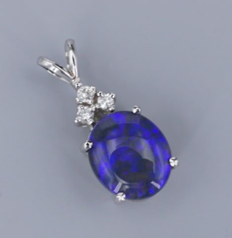 14k White Gold Natural Black Opal Diamond Pendant Statement Vintage PG2040: This beautiful statement pendant features fiery natural black opal displaying flashes of purple framed in 14k white gold and accented with natural diamonds. This classic piece is perfect for yourself