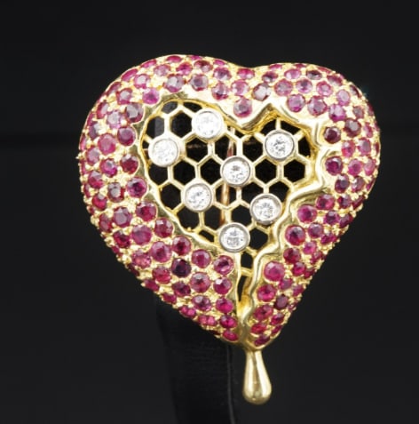 Henryk Kaston for Salvador Dal? Ruby and Diamond Honeycomb Heart Brooch PG1717: This beautiful 3D brooch was designed for Salvador Dali by Henryk Kaston as an asymmetrical heart pave set with round rubies, the center featuring an openwork honeycomb pattern decorated with round di