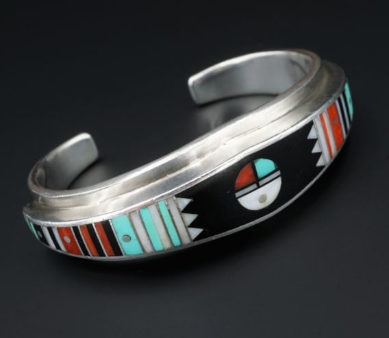 Ernest Benally Sunface Mosaic Inlay Sterling Silver Cuff Bracelet 6" BS2724: This unique Benally vintage cuff has vivid colorful precise bars and geometric shapes of turquoise, coral, onyx, and mother of pearl inlaid into the entire face of this tapered cuff bracelet. An amazi