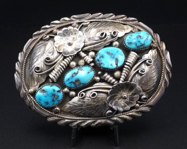 Vintage Navajo Sterling Silver Turquoise Belt Buckle 3.4" Fred James M1867: This large mid-century sterling silver belt buckle features four gorgeous natural turquoise nestled between raised floral, feather, and swirled details. Hand-stamped detailing ring the edges of the bu