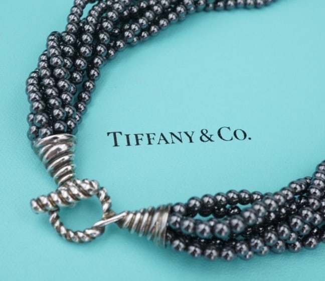 Tiffany Torsade Hematite Bead Necklace Sterling Silver Toggle 17" Folder NS2144: This stunning necklace from Tiffany & Co. features 8 strands of lustrous hematite beads measuring in at 4mm each with a sterling silver toggle clasp. This necklace is sure to make a statement! Comes w