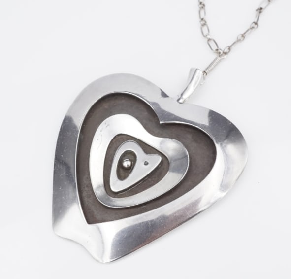 Navajo Norbert Peshlakai Sterling Silver Abstract Pendant Necklace 24" NS2286: This Navajo pendant necklace by artist Norbert Peshlakai features unique apple shaped pendant layered with abstract shapes. Suspended from a hand crafted chain, this piece is perfect for any collector
