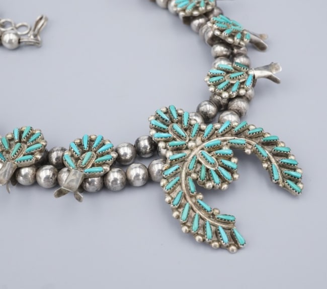 Petite Zuni Turquoise Squash Blossom Necklace Sterling Silver 21" Acque NS2312: This beautiful Zuni necklace, from Gloria Acque, features a gorgeous squash blossom design adorned with petite point turquoise cabochons bezel set in sterling silver frames. A great addition for any c