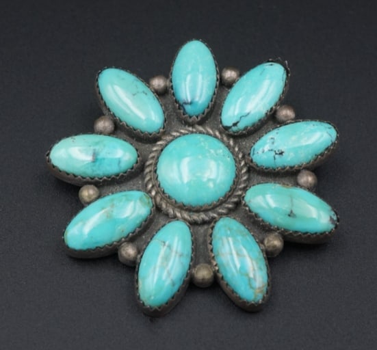 Navajo Turquoise Brooch Sterling Silver William Anderson Pin 2.75" Artisan OS627: This Navajo pendant features bezel set turquoise cabochons set among silver beads in a floral bow design. Wear this piece as a brooch or add a cord to wear it as a pendant for maximum versatility. All