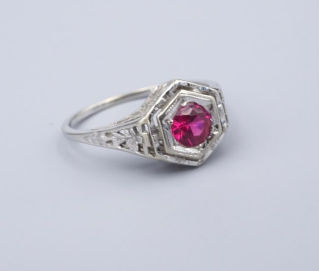 10k Vintage Ruby Filigree Cocktail Ring White Gold Size 6.5 RG4804: This beautiful vintage ring centers on a lab-created ruby prong set atop a delicate white gold filigree hexagonal dome with cut-through accents. This stunning ring is perfect as an alternative engagem