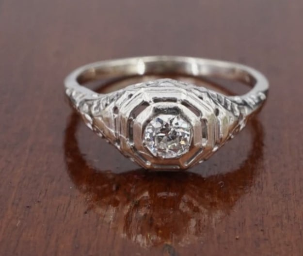14k White Gold Art Deco Natural Diamond Promise Ring Filigree Size 6.5 RG4825: This gorgeous ring features a stunning natural old cut white diamond solitaire prong set atop a 14k white gold dome mount with ornate filigree details. This exquisite ring is a stunning accessory for 