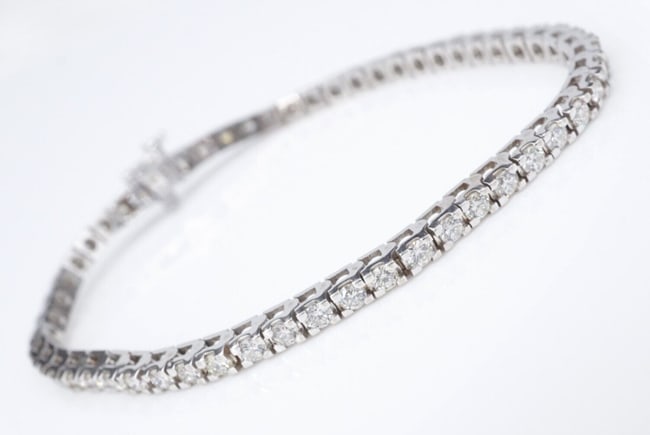 Classic 14k White Gold 3 carat Natural Diamond Tennis Bracelet 7" In Line BG892: This in-line diamond bracelet is a true petite classic! The diamonds are set individually in 4 prong 14k white gold baskets for maximum security and a sleek modern look. The bracelet fastens with a se