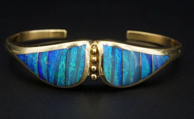Natural Black Opal Inlay Cuff Bracelet Designer Lisa Mele 18k Gold BG717: This amazing bracelet features inlays of natural Australian black opal across the face of an 18k yellow gold cuff design. An amazing hand-crafted piece from artist Lisa Mele. Metal Type: 18k Yellow Go