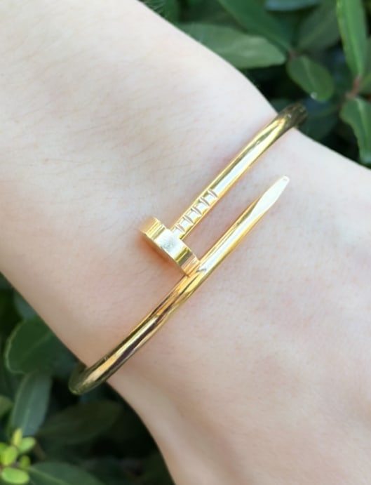 Cartier 18k Pink Gold Nail Bracelet Size 17 Juste un Clou New Style Auth BG940: From the "Juste un Clou" collection, this classic bangle is crafted of solid 18k pink gold. New closure system. Metal Type: 18k Yellow Gold Notable Marks: Cartier 15 Au 750 serial number Measurements: