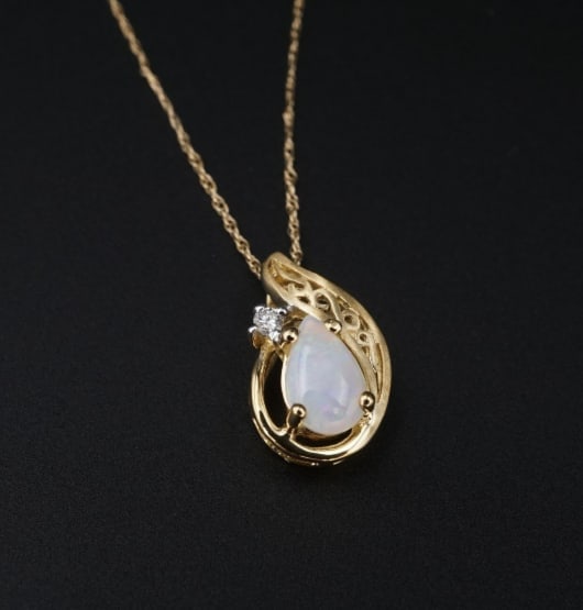 Vintage 14k Opal Diamond Necklace Pendant Yellow Gold Teardrop 18" NG1509: This beautiful petite pendant necklace features a teardrop opal cabochon accented by a sparkling white diamond. All set in 14k yellow gold and accented with delicate open scrollwork. It is paired with