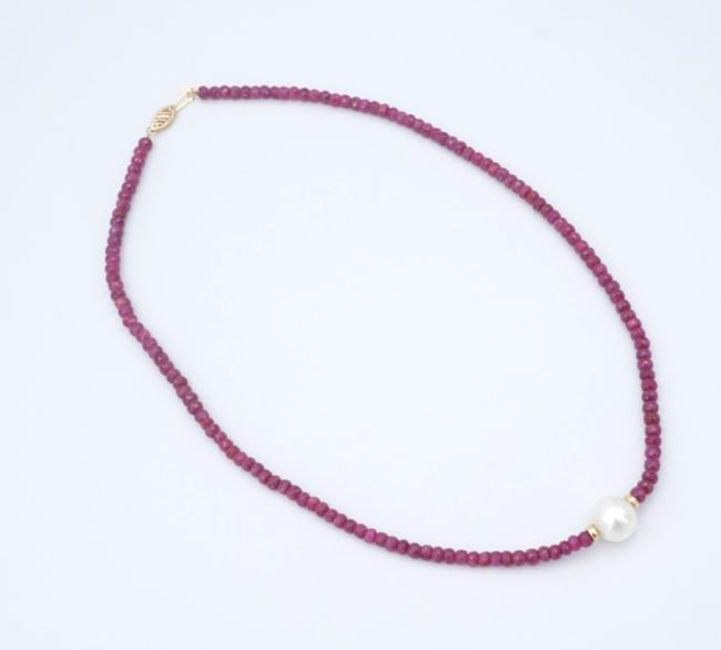 Vintage Ruby Bead Strand Pearl Necklace 14k Yellow Gold 18" 4.1mm NG1809: This gorgeous vintage necklace features a vivid strand of ruby beads with a large pearl accent in the center. Complete with 14k yellow gold accents, this classic design is perfect on its own or in you